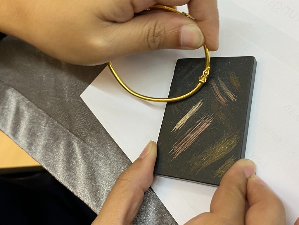 gold testing black stone